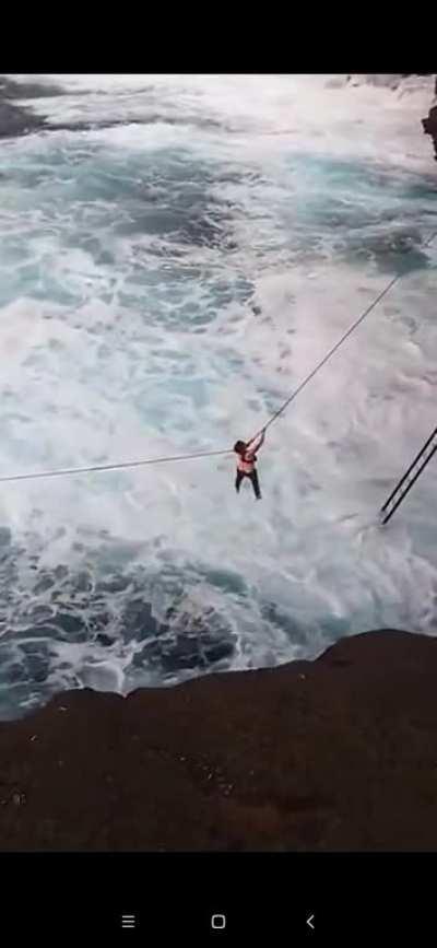 Cliff diving in heavy swell, Hawaii