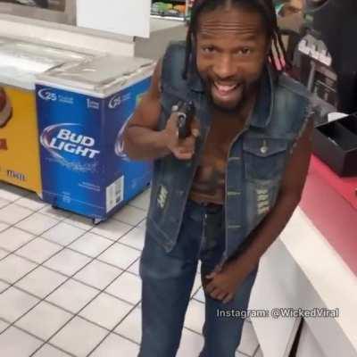 Flexing his pistol at a store.. man also has a swastika tatted on his belly 🤦‍♂️ (IG: WickedViral)