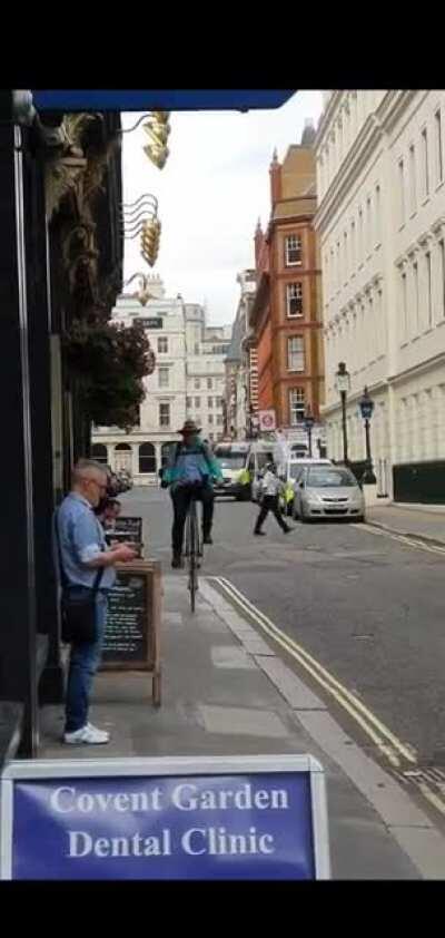 Deliveroo courier in Covent gardens on a penny farthing.