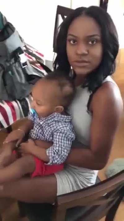 Man slaps woman while she's holding her baby