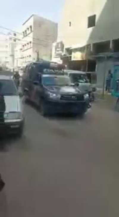 Old man dancing in front of police cars