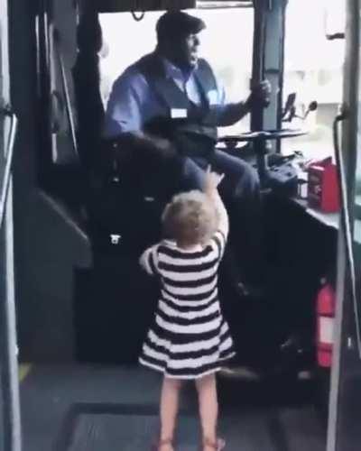 Bus driver and kid enjoy a dance off
