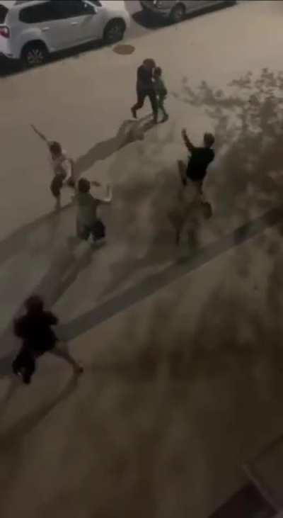 Dad, mom, and son against what looks like three teens