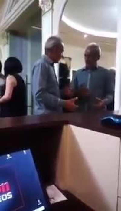 Two drunk gentlemen try to pass each other