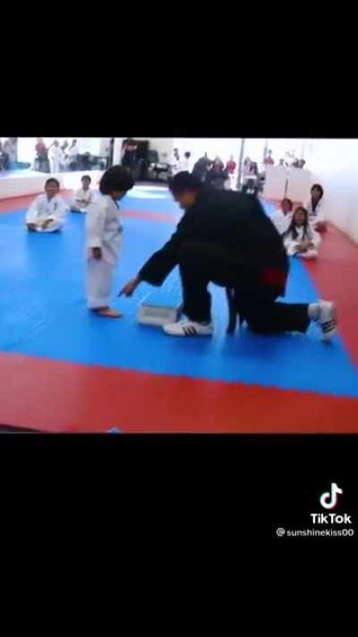 To break a board with a karate step