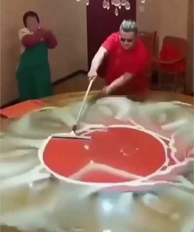 Chinese Guy Fieri cleans a glass table.