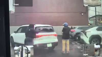 A guy tries to block a woman from backing into a parking spot