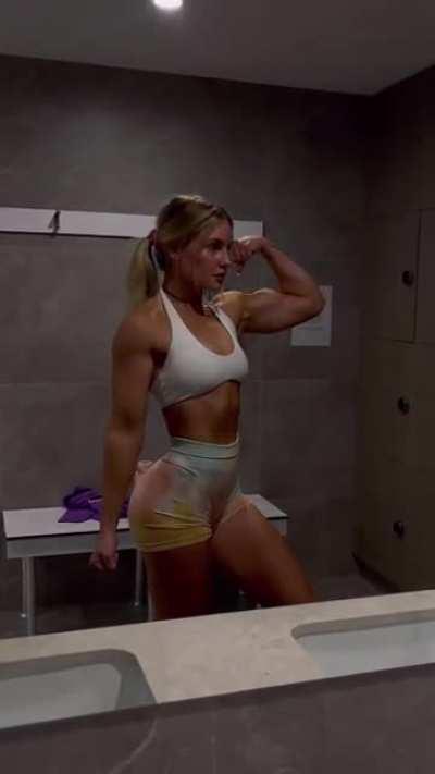 Blonde flexing biceps