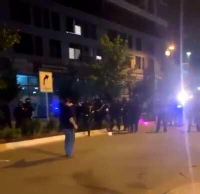 Protester gets a flash-bang to his face after getting pepper sprayed.