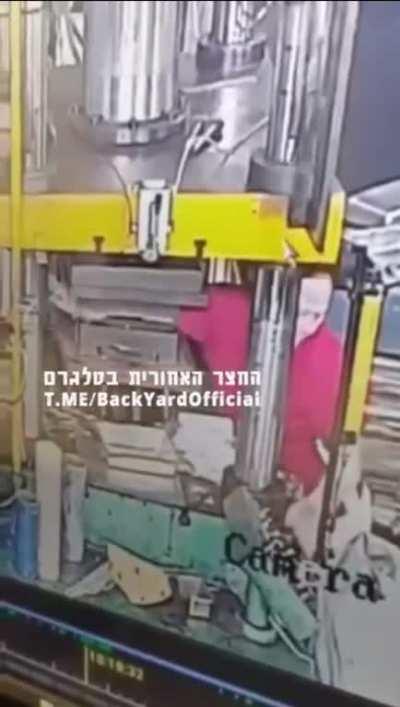 Woman flattens arm in a hydraulic press