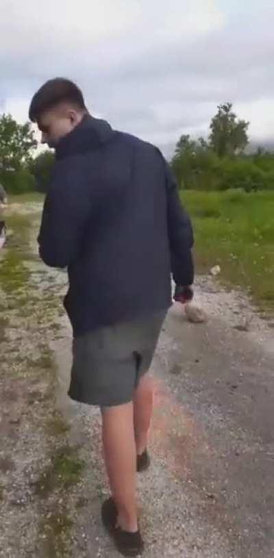 My friend blowing spray paint up in his face