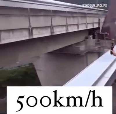 People reacting to the new Japanese Maglev bullet train passing right by them during a test run.