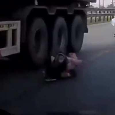 Mother saves son from being crushed under the wheels of truck with lightning fast reactions in heart-stopping footage