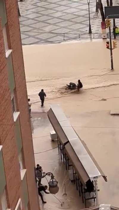 Mom of the year tries to cross floodwaters with a stroller