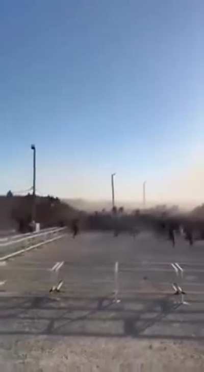 Starving Palestinians who braved the IDF killing fields breach the fence of an aid distribution point like a scene from a zombie movie