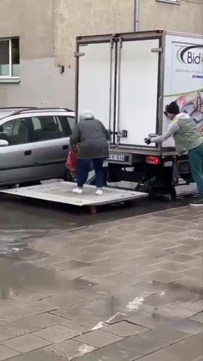 A truck driver helps an elderly woman to reach her car! (Vilnius, Lithuania)