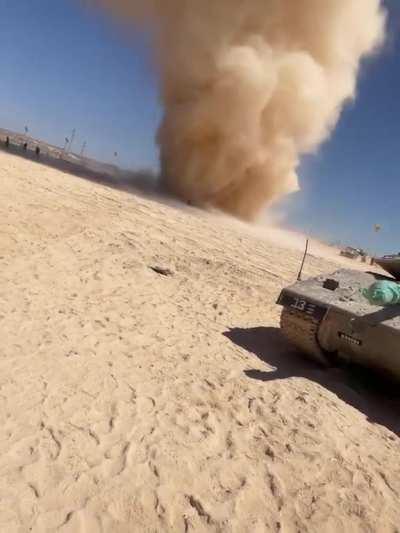 Men run toward massive dust devil