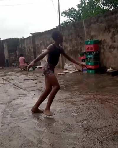 Anthony from Nigeria Dancing ballet barefooted on concrete while raining.