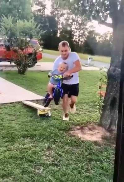 Dad helping his little guy feel the moment