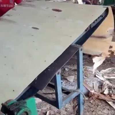 Peeling a log into veneers. Plywood results when they are press-glued together