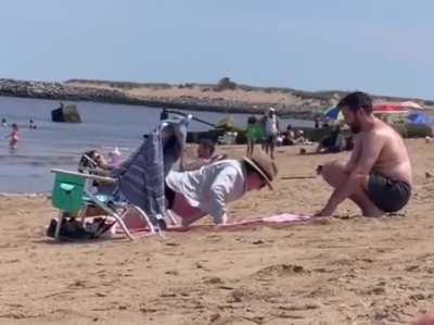 This guy dug a hole in the sand so his pregnant partner could lie in her stomach