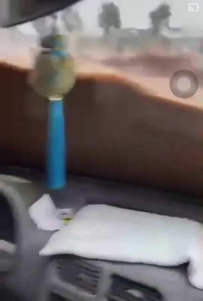 Man stuck inside of car during flood. (China)