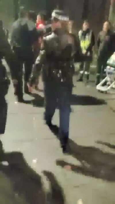 An Australian Communist Party supporter being escorted out of this morning's Sydney ANZAC Day dawn service and issued with a move on order for the crime of displaying a Communist flag. (Party statement below in the comments)