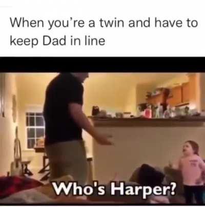 Toddler twin makes sure her dad knows which one is which.
