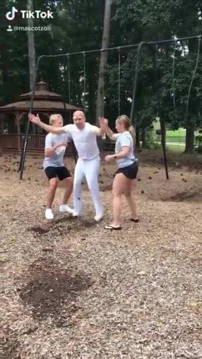 Guy backflips off a swing, lands in a pair of pants, somersaults, and scoots across the ground like a boss