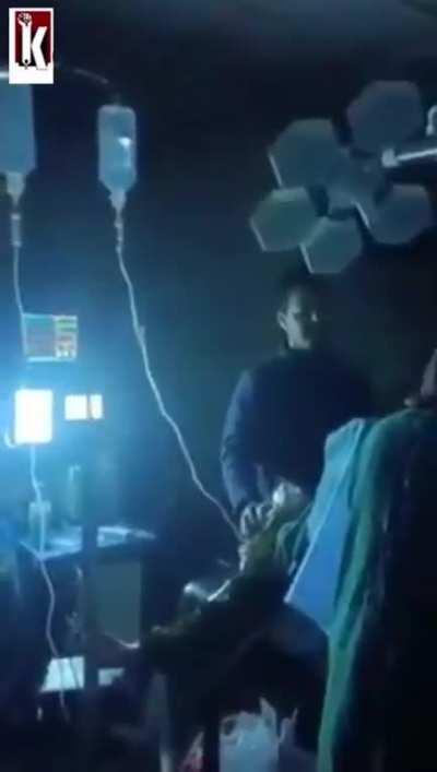 Doctors praying while delivering a baby amid earthquake in Kashmir.