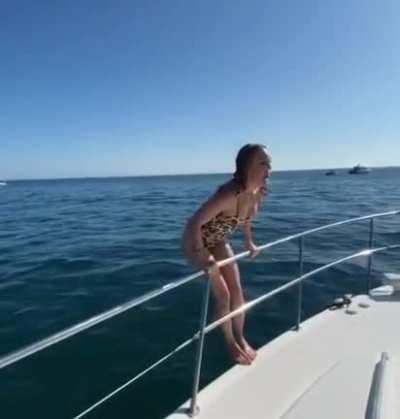 In A Swimsuit Jumping Off A Boat