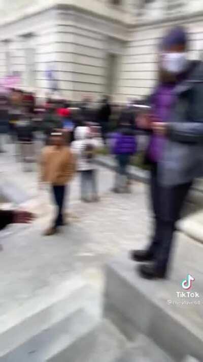 The surreal moment that a Trump supporter begs cops to intervene in the Capitol riots.