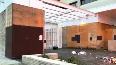 [Alternate Angle] Anarcho-Democrats/Antifa attack Federal immigration jail in broad daylight by rolling flaming dumpster near plywood-covered building