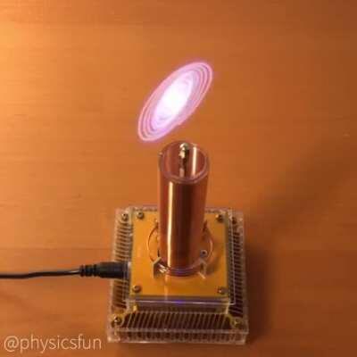 Corona Discharge Trajectories: the ejected electron stream propels the end of a thin wire connected to a miniature Tesla coil.