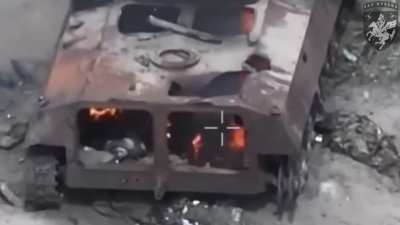 The occupier, engulfed in flames, tries in vain to climb out of the burning armored vehicle.