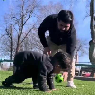Father and son playing football