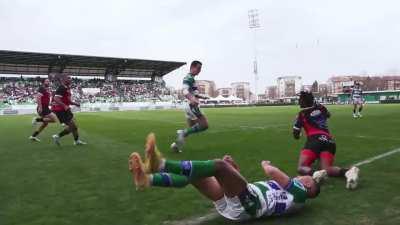 TV cameraman runs alongside rugby players