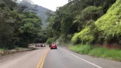 Idiot driving down a mountainous road gets impatient, irresponsibly overtakes from the right and crashes his car