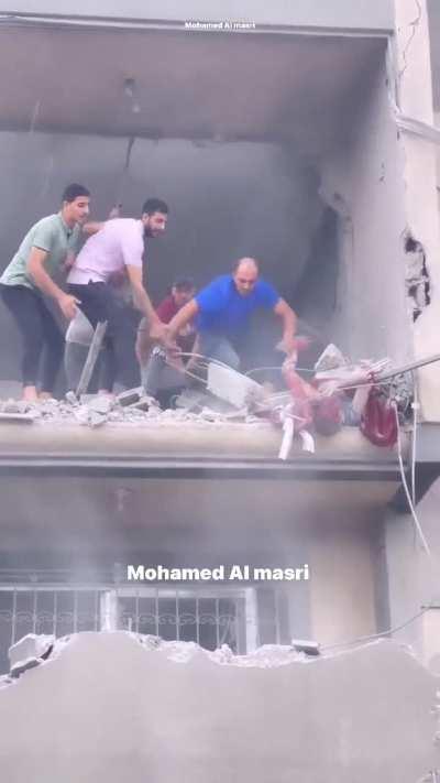 A civilian being rescued from a destroyed building in northern Gaza
