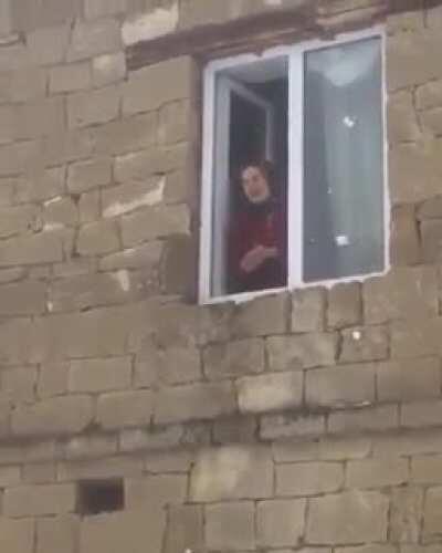 Babushka throws snow at friend