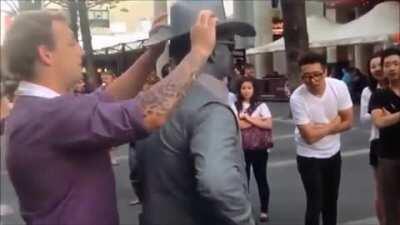 Street performer breaks character to deal with heckler