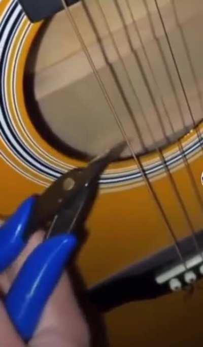 dude cuts his guitar string