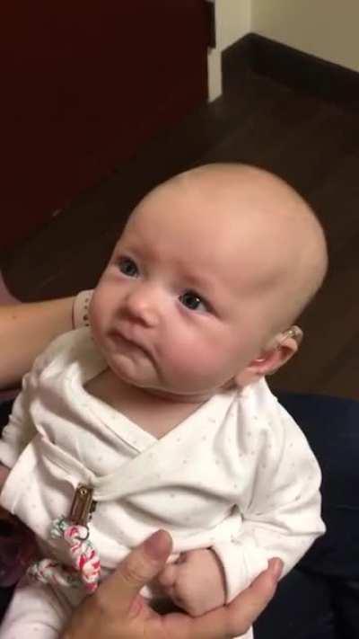 Baby hears mothers voice for the first time with the help of a hearing aid. the reaction is beautiful.