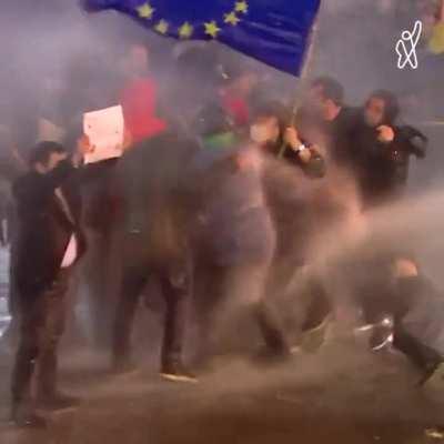 Georgian protesters rallying when hosed by riot police