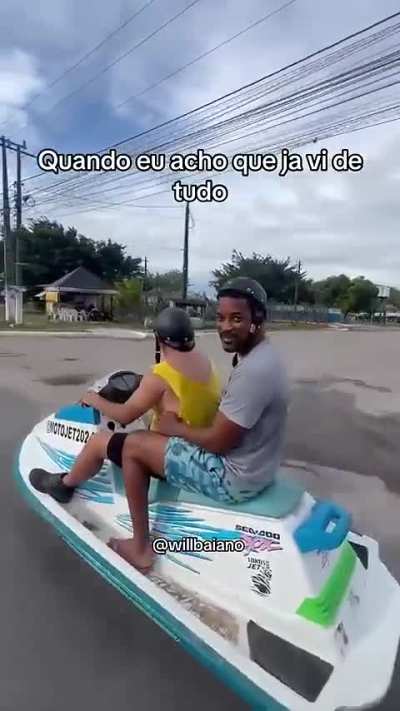 Jackie Chan and Will Smith riding a jet ski on the asphalt in Bahia because why not?