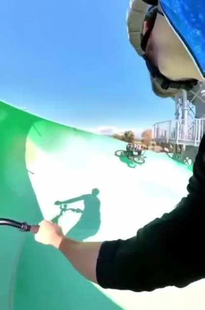 Racing down the waterslide on bike