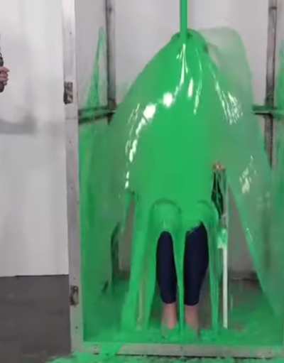 Cute brunette disappears from view in a cascade of green gunge