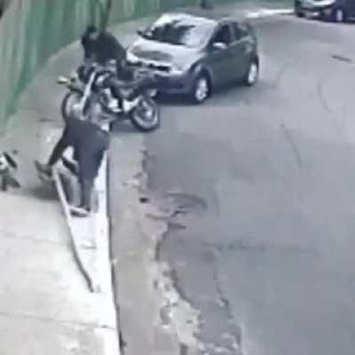 Motorcyclist attempts robbery gets taken out by passing car
