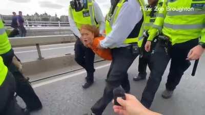 a media interview while being carried away by police for protesting.