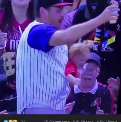 Releasing the baby that he is holding for 1 second to catch a baseball while holding a beer in the other hand